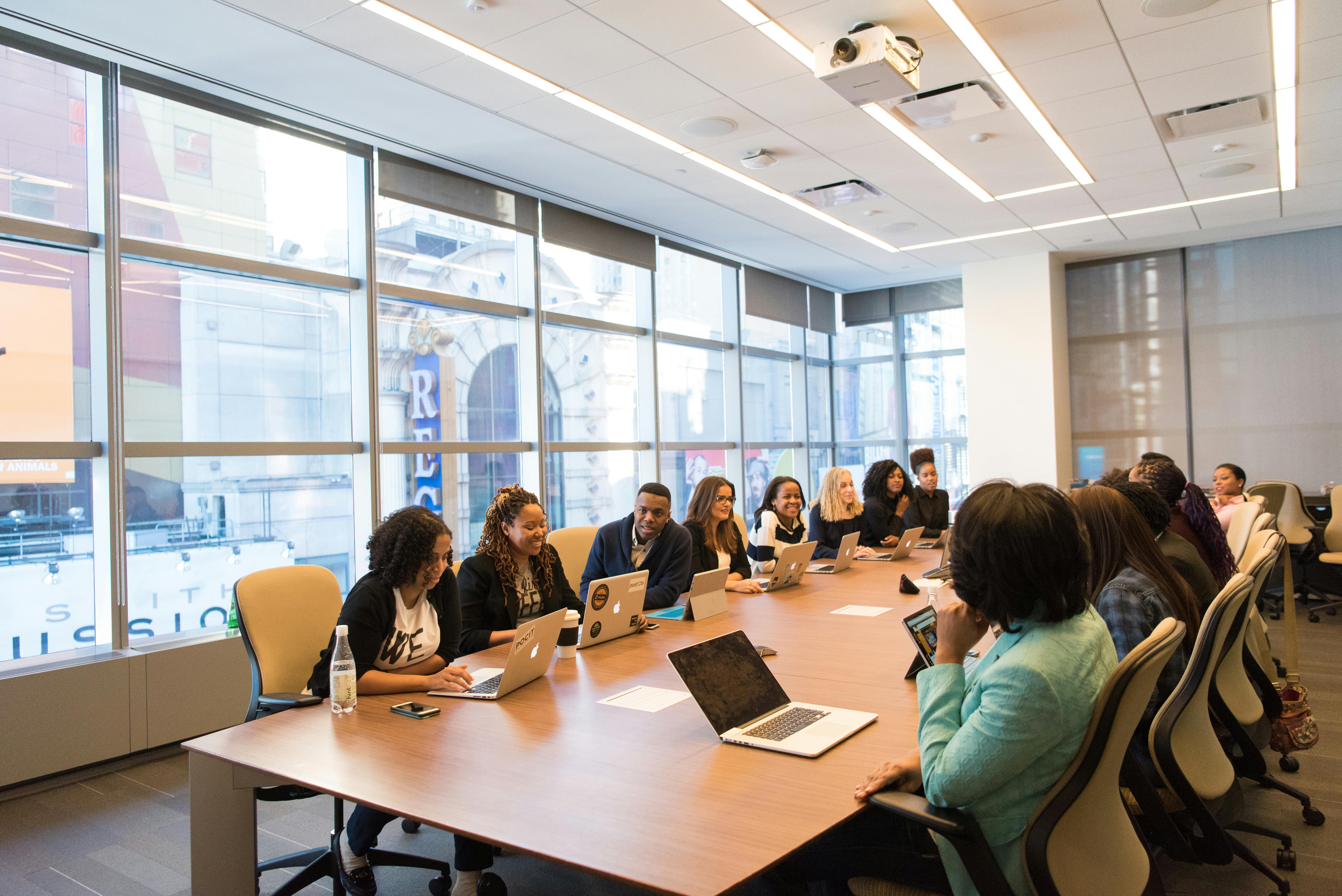 Diverse group of medical professionals collaborating in a modern conference room during curriculum training session